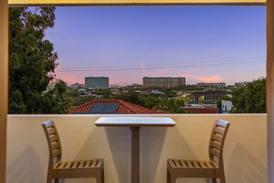 Balcony dining with open city views in Aruba