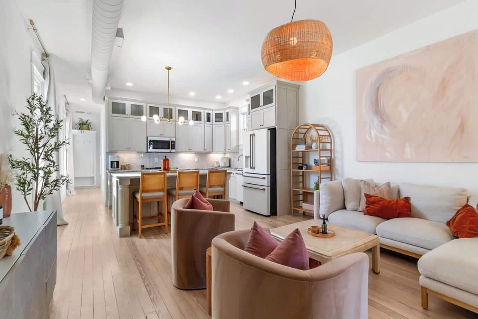 Living Area: A pristine, light-filled living room with cozy furnishings and a calm, welcoming ambiance.