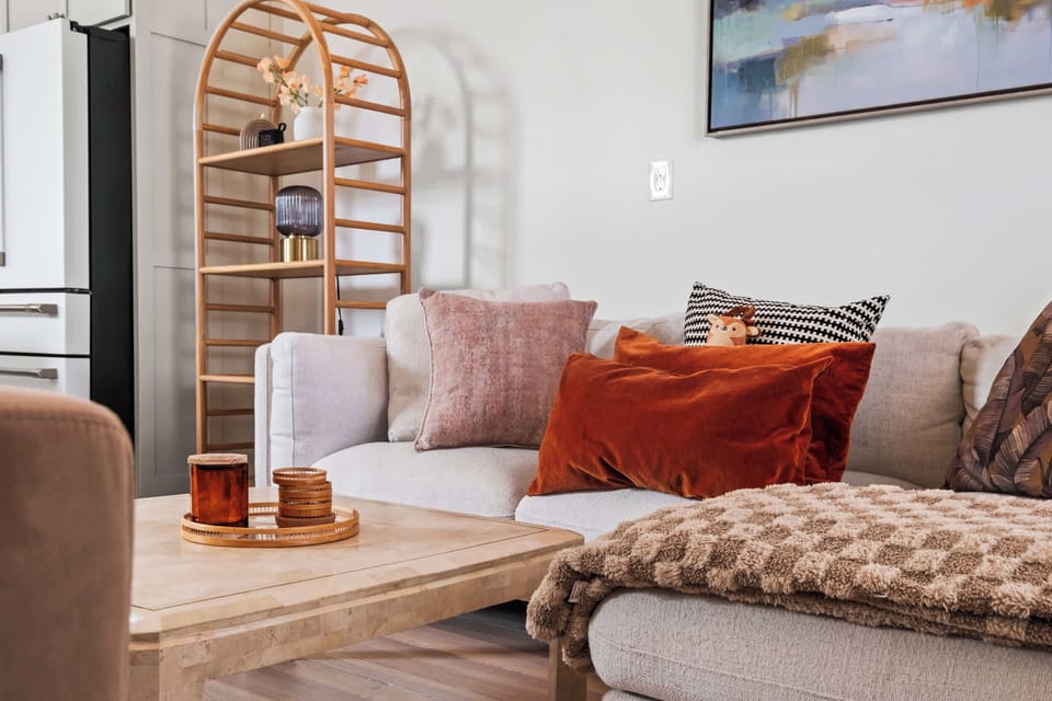Living Area: A pristine, light-filled living room with cozy furnishings and a calm, welcoming ambiance.