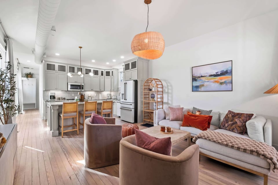 Living Area: A pristine, light-filled living room with cozy furnishings and a calm, welcoming ambiance.