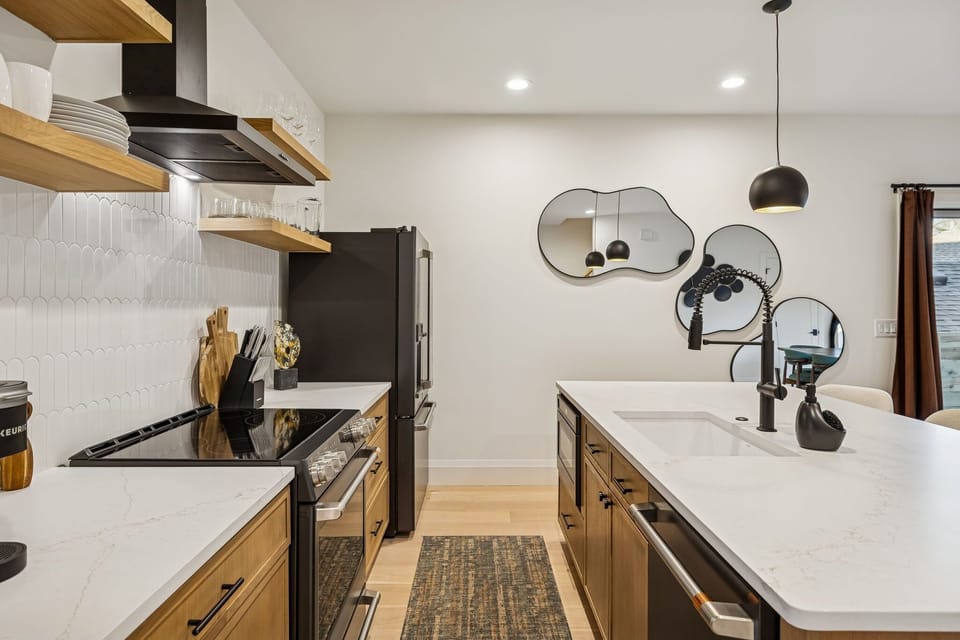 Kitchen: Cook, snack, and gather in this sleek modern kitchen—fully equipped and ready for big-group meals and unforgettable moments.