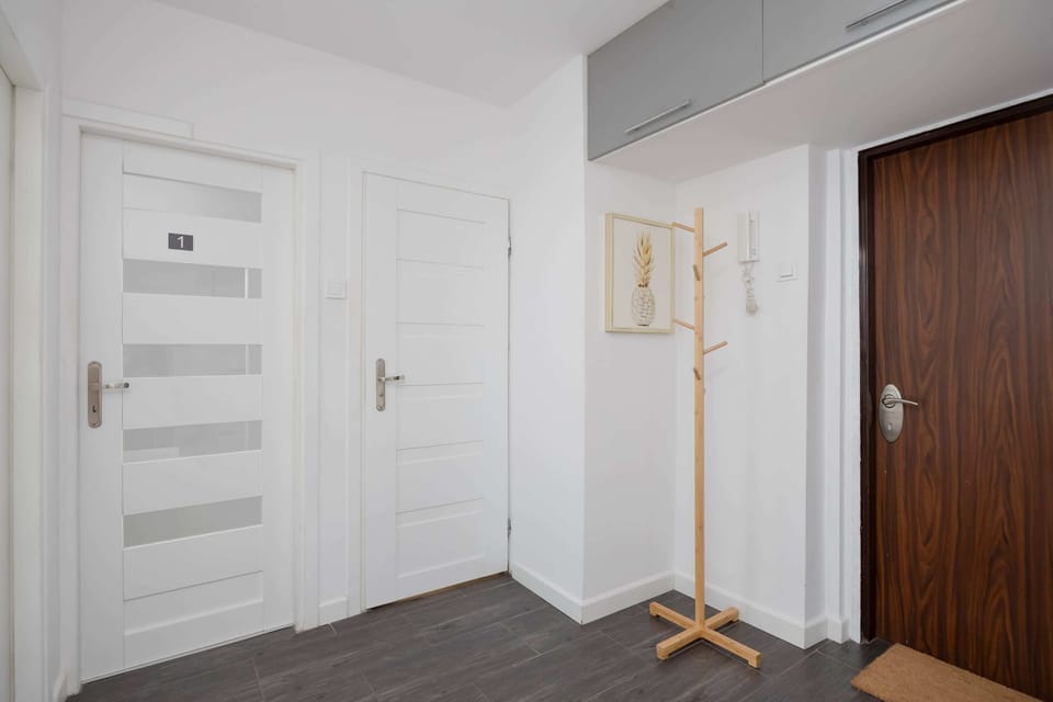 Neat entrance area with doors and clean finishes.