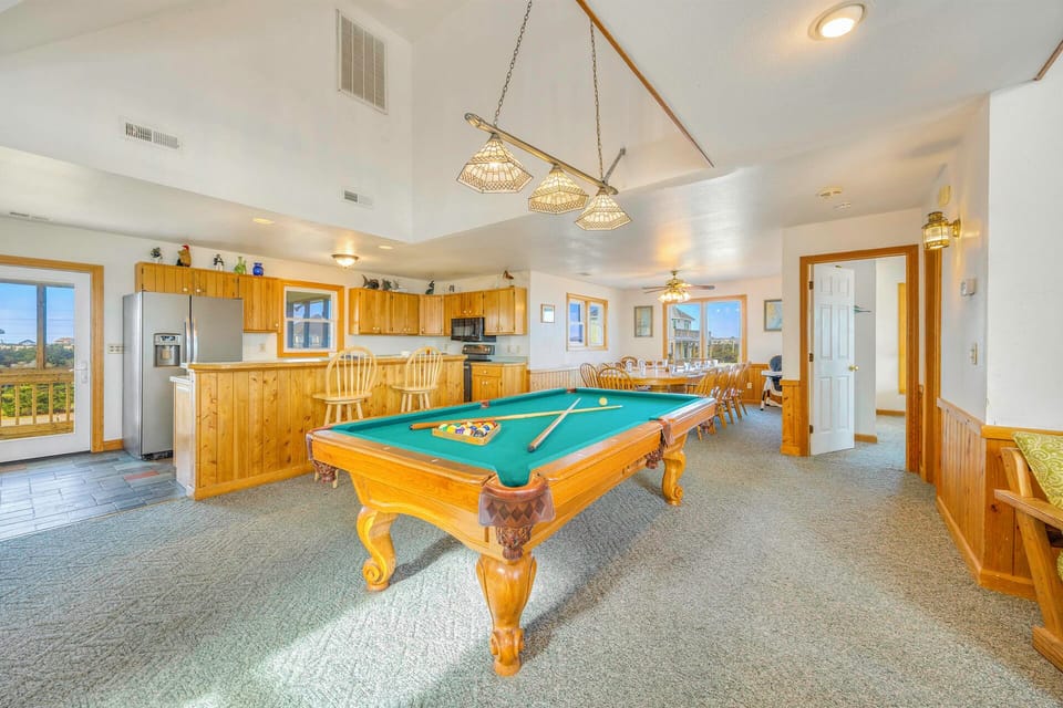 Step into your entertainment paradise where you can challenge friends to pool while preparing meals in the open kitchen.