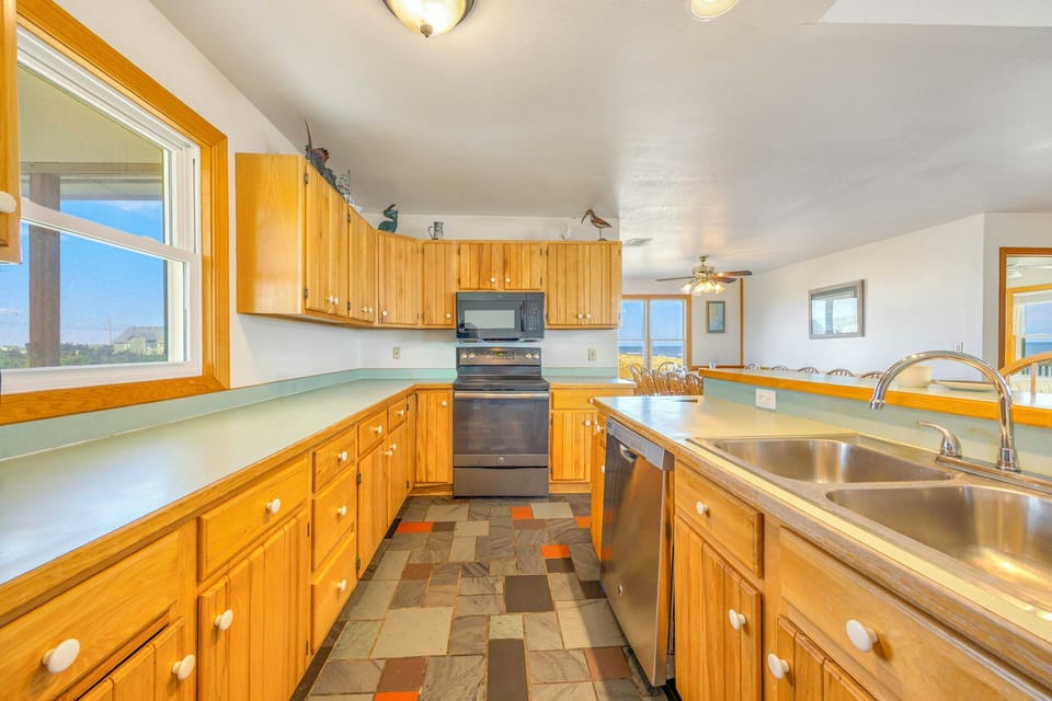 Spacious kitchen with warm wood cabinets, modern appliances, and mountain views to inspire your culinary adventures.