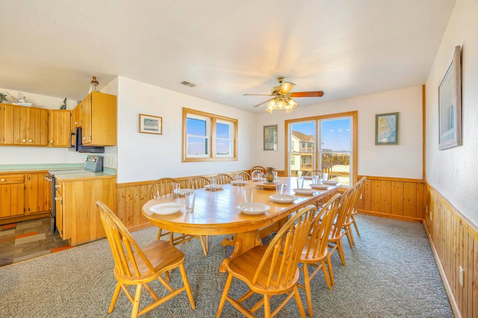 Gather your family around this expansive dining table for memorable meals, with warm wood accents and a well-equipped kitchen ready for your culinary adventures.