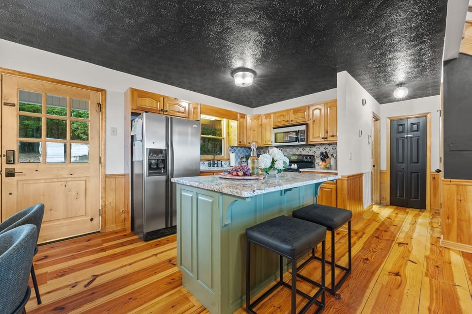 Fully stocked kitchen for meal prep including a dishwasher, stove/oven, microwave and fridge. 