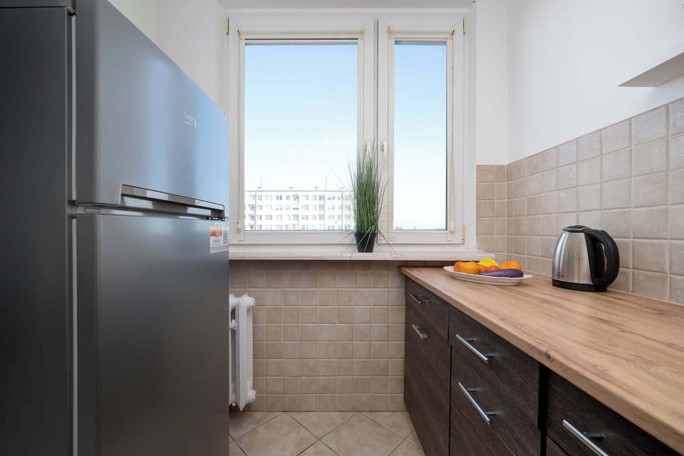 Kitchen with fridge and countertop workspace.