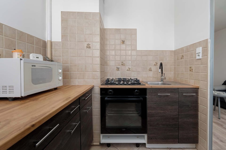 Kitchen with oven, hob, and worktop.