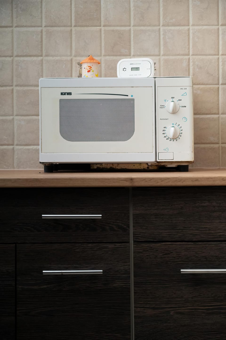 Microwave and kitchen storage units.