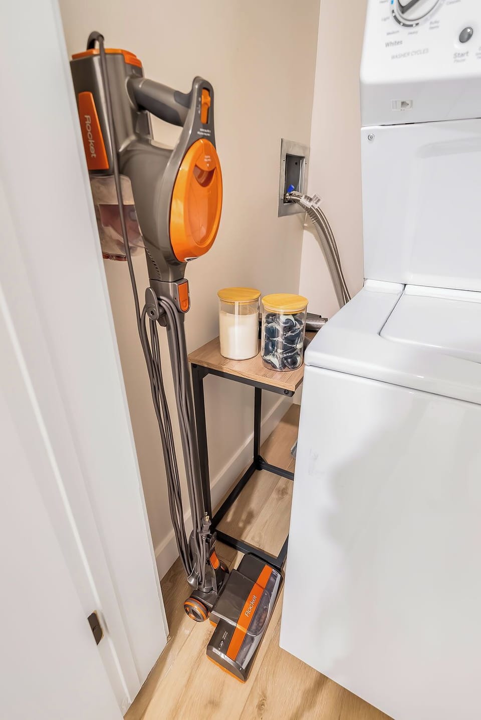 Your laundry nook features convenient storage and a handy vacuum for keeping your space spotless during your stay.
