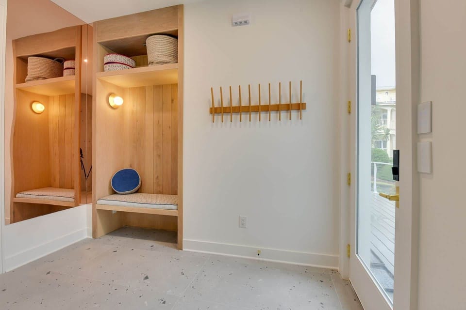 Sand room entry with bench and hooks for beach gear and towels