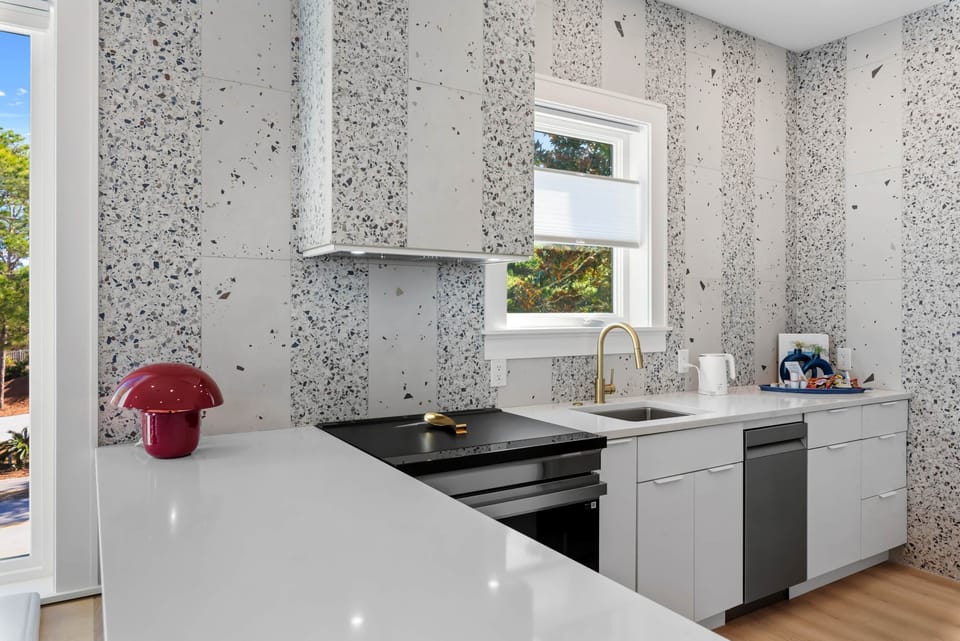 Modern guest house kitchen featuring terrazzo finishes and thoughtful design details