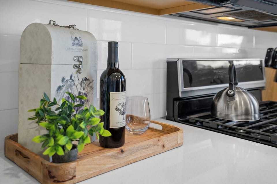 Your fully equipped kitchen awaits with quality appliances and thoughtful touches like wine glasses ready for your evening unwind.