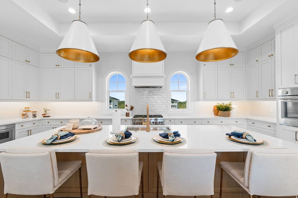 Your gourmet kitchen awaits with gleaming countertops, statement pendant lights, and everything you need to create memorable meals together.