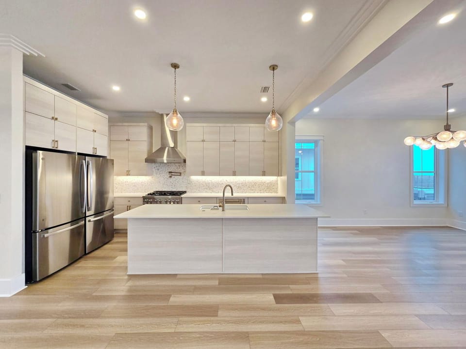 Your spacious modern kitchen features gleaming countertops, stainless steel appliances, and elegant pendant lighting for memorable meal preparations.
