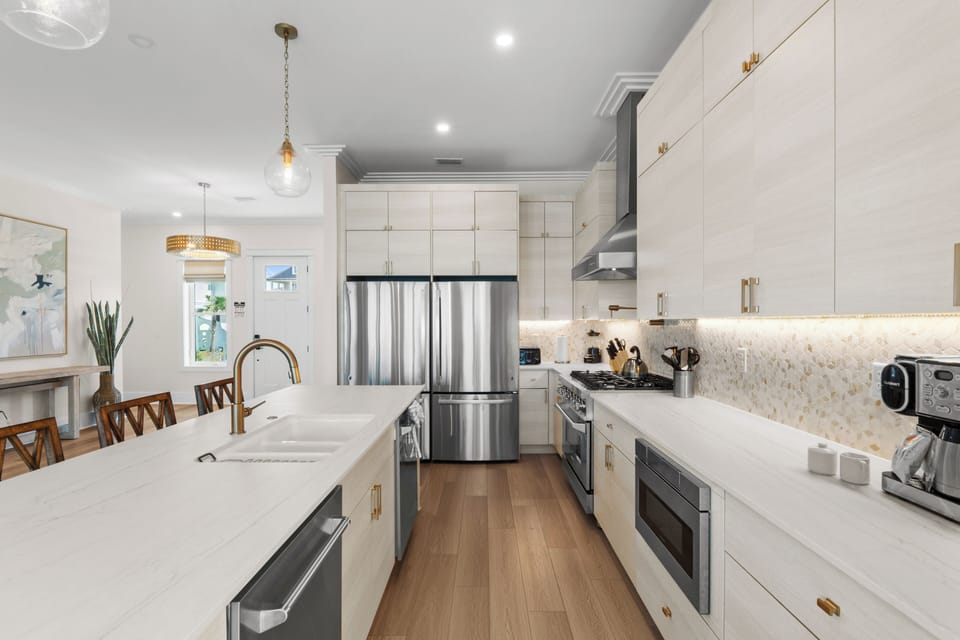 Step into your dream kitchen where gleaming countertops and custom cabinetry await. The expansive island is perfect for meal prep or morning coffee, while warm wood floors guide you through this bright culinary haven.