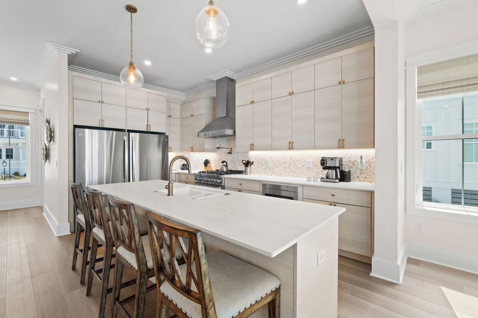Your vacation starts in this bright, modern kitchen with a spacious island for gathering, high-end appliances, and elegant pendant lighting that sets a welcoming tone for shared meals and morning coffee.