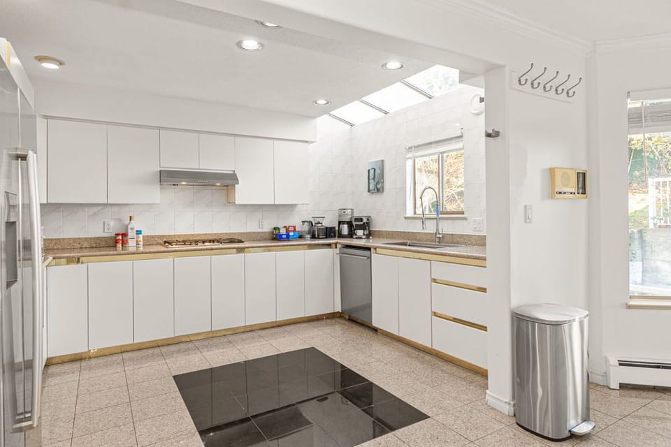 Spacious kitchen with coffee machine, kettle, and basic cooking essentials