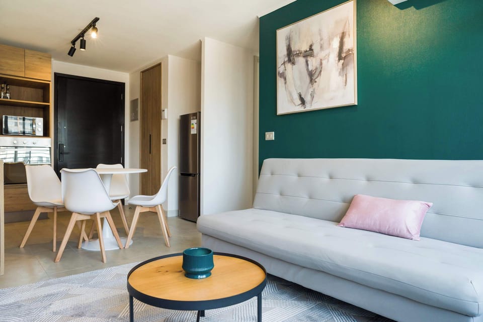 Stylish and cozy living space with modern decor and a welcoming dining area, perfect for relaxation and meals.