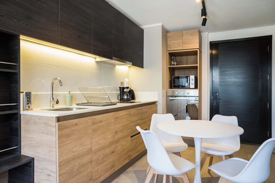 Sleek and modern kitchen with dining area, perfect for enjoying meals in comfort.