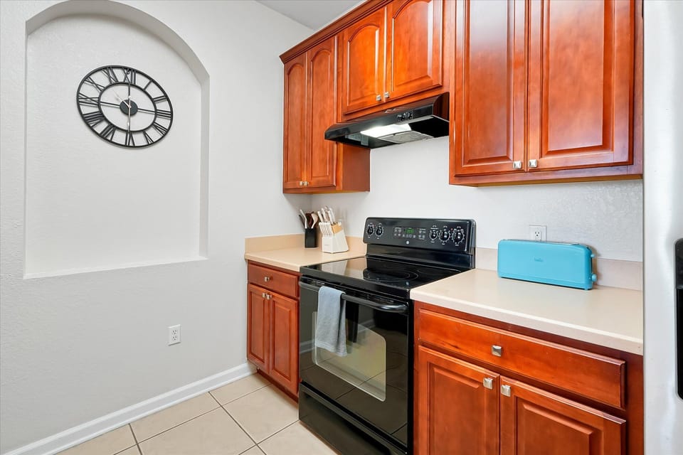 Cook your favorite meals in this well-equipped kitchen featuring rich wood cabinets, modern appliances, and plenty of counter space for your culinary adventures.