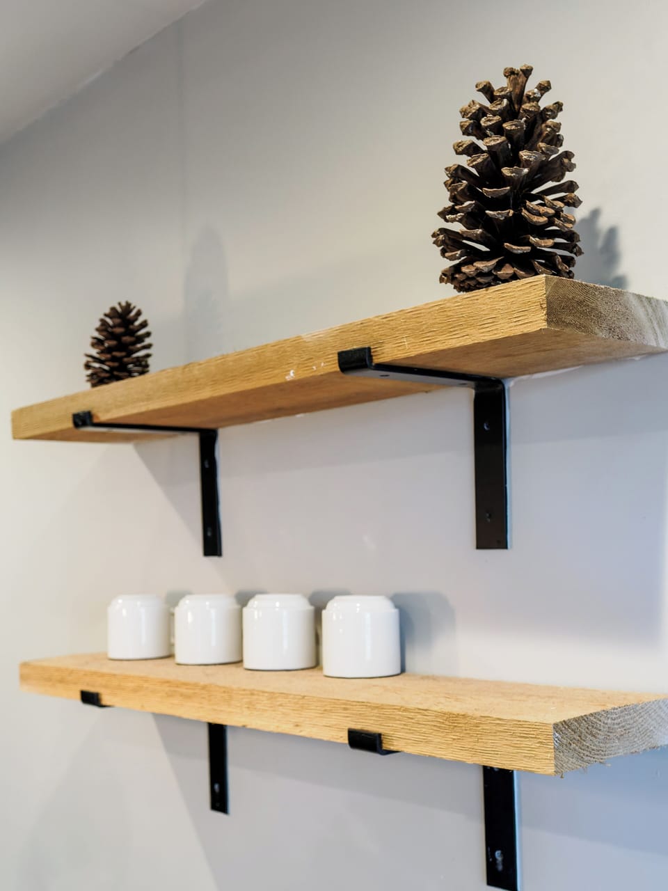 You'll love the thoughtful rustic touches in your space - natural wood shelves display charming pinecones and ceramic accents that make it feel like home.
