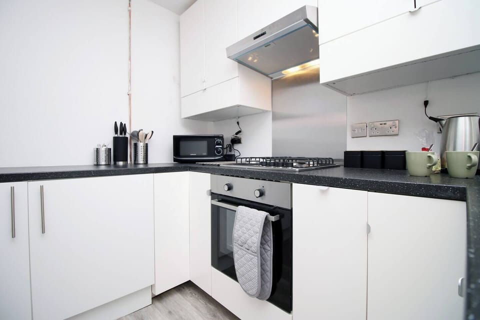 The fully equipped kitchen is ready for your culinary adventures, with everything you need to make delicious homemade meals. 