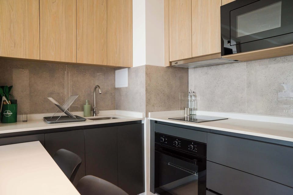Sleek and modern kitchen with all essential amenities for a comfortable stay.