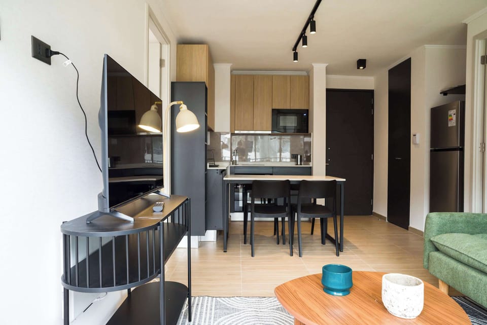 Modern living area with sleek kitchen and cozy seating, perfect for relaxing after exploring the city.