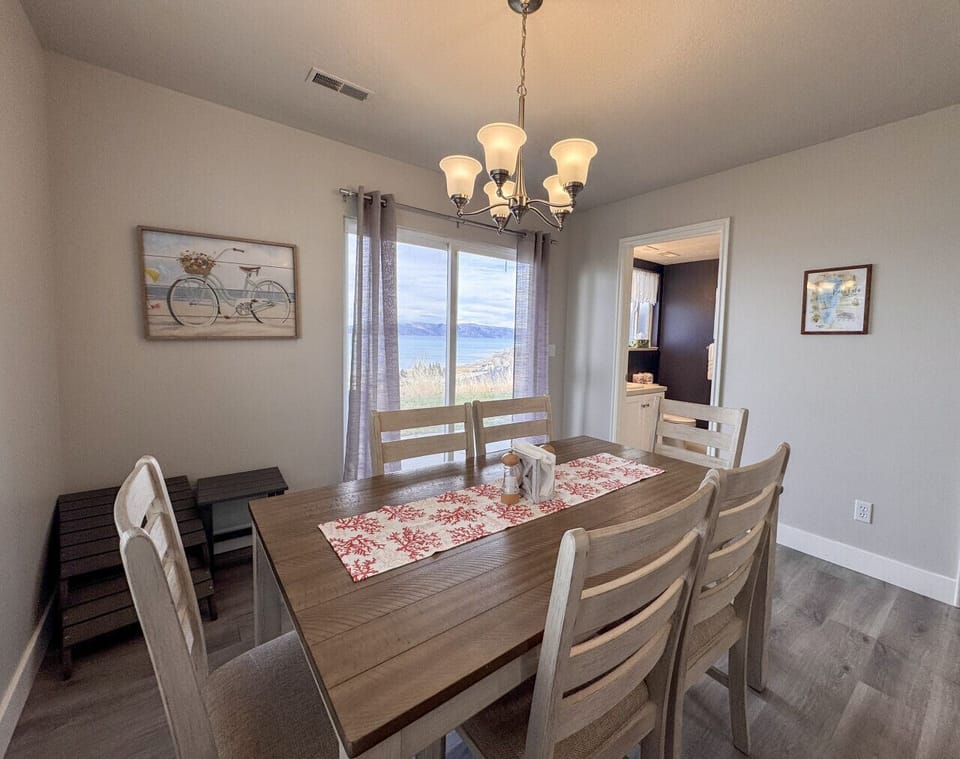 Cozy dining room with warm lighting and stunning lake views—perfect for memorable meals together.