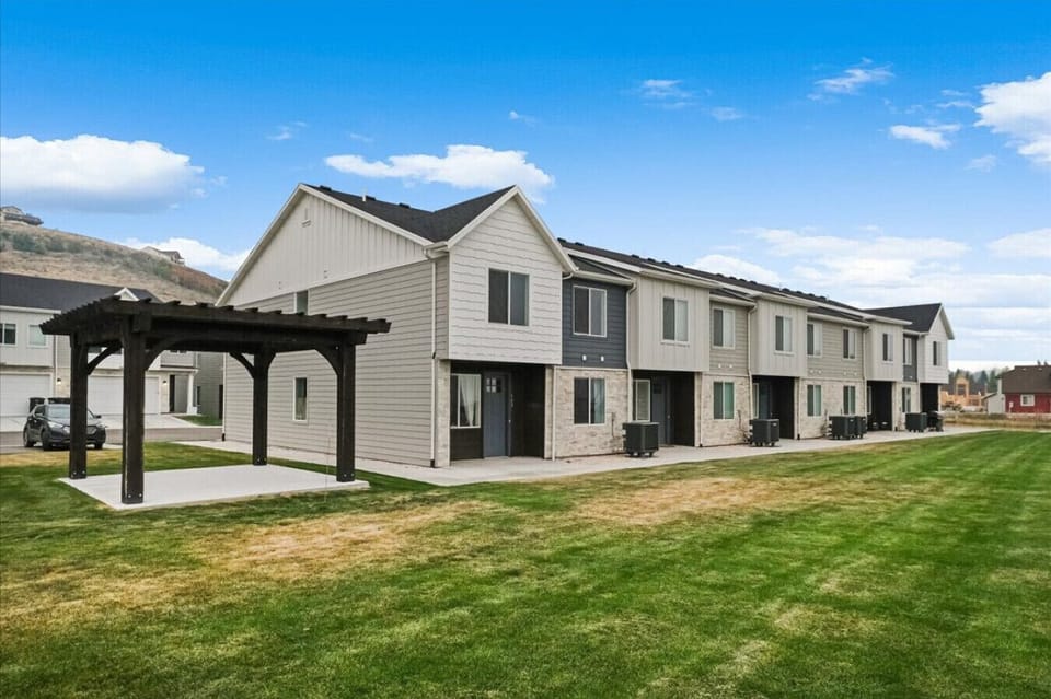 Charming modern townhome with spacious green lawn and peaceful mountain views for a relaxing outdoor getaway