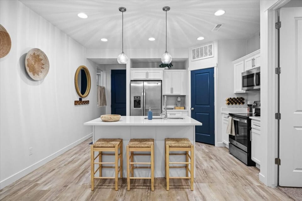 Bright, stylish kitchen with warm accents, spacious island seating, and modern appliances for effortless gathering