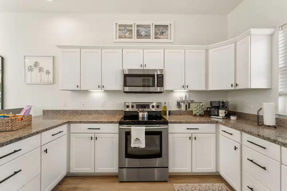 Modern granite countertops paired with sleek stainless appliances.