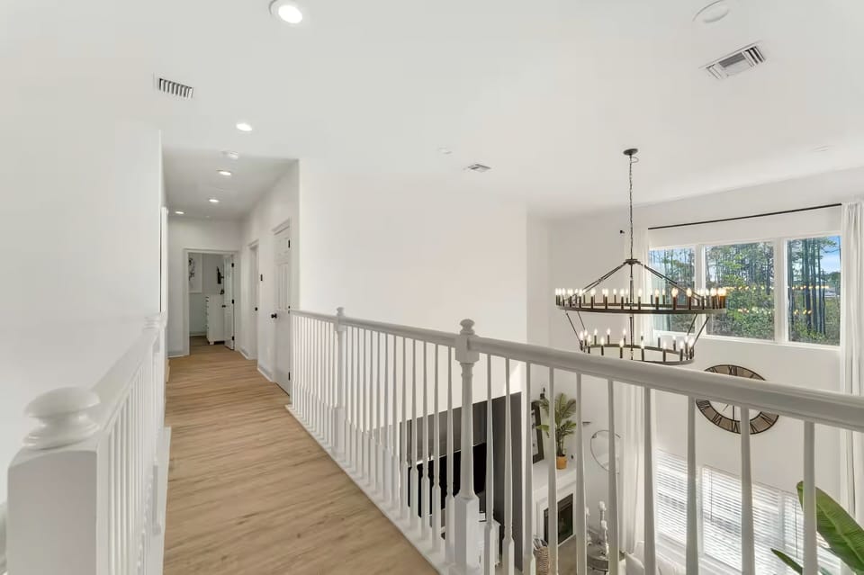 The upstairs landing feels bright and open, overlooking the main living area below.