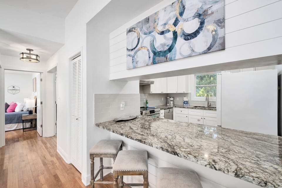 Gather around your stunning granite breakfast bar, perfect for morning coffee or casual meals. The bright, airy kitchen flows seamlessly, inviting you to feel right at home.