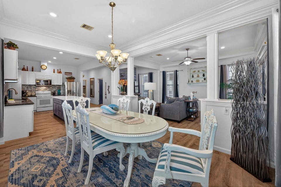 Your elegant dining space flows seamlessly into the kitchen and living areas, perfect for memorable meals and conversations together.