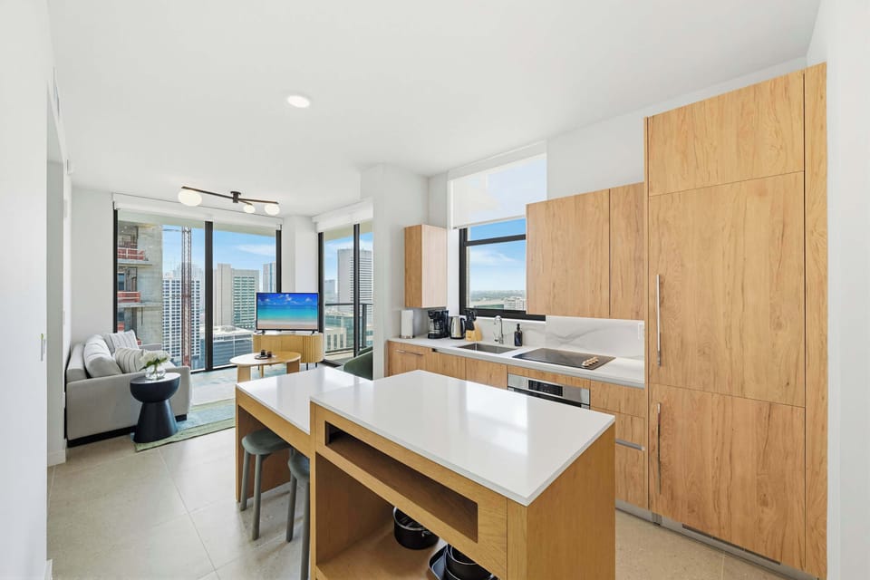The kitchen features a sleek, modern counter with bar seating