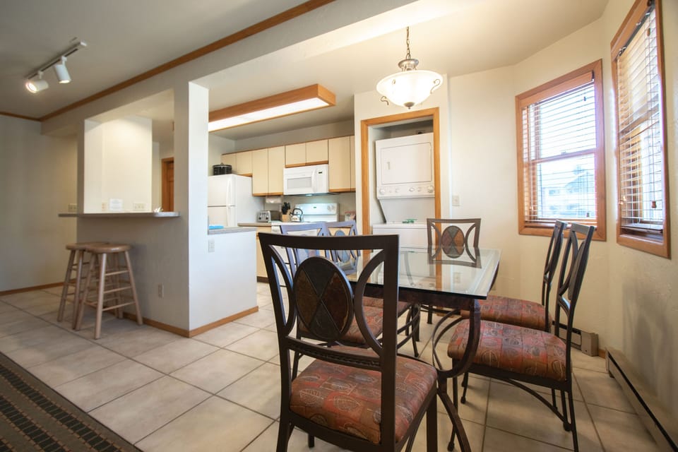 The dining area with seating for six invites gatherings, while the open layout enhances social interaction with the kitchen.
