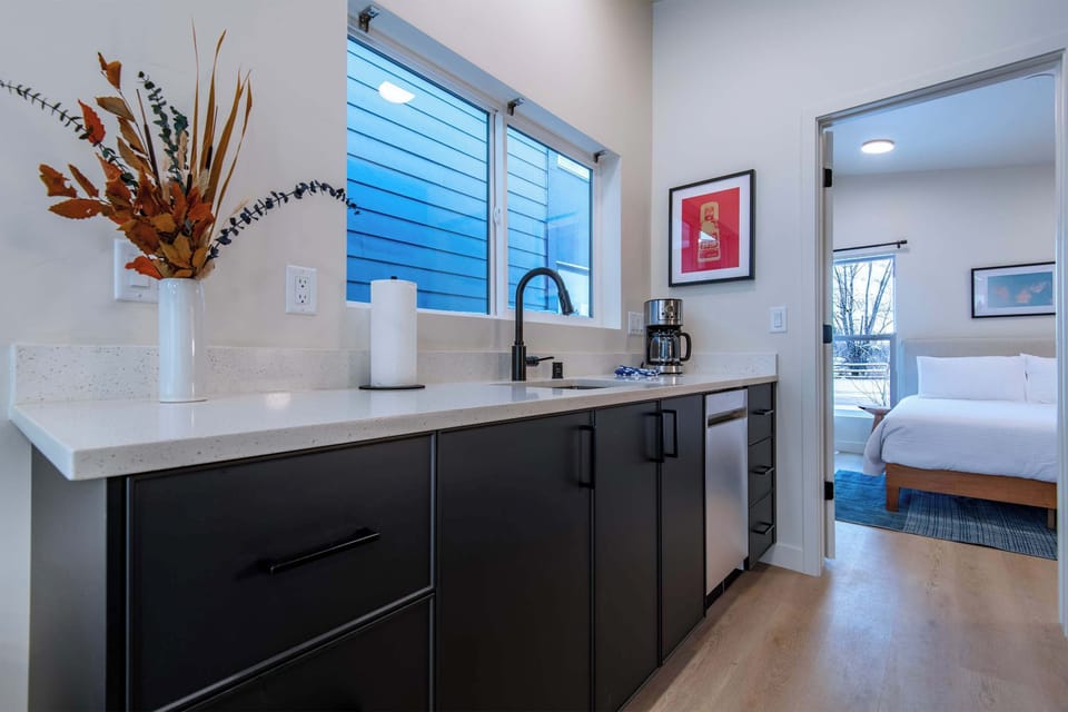 Fully equipped kitchen leading to the bedroom.