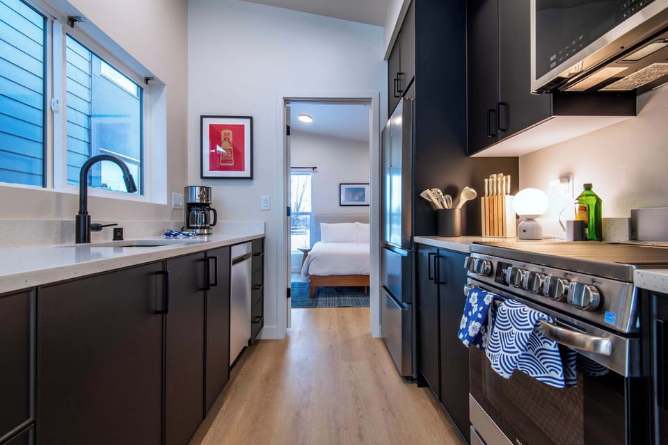 Fully equipped kitchen leading to the bedroom.