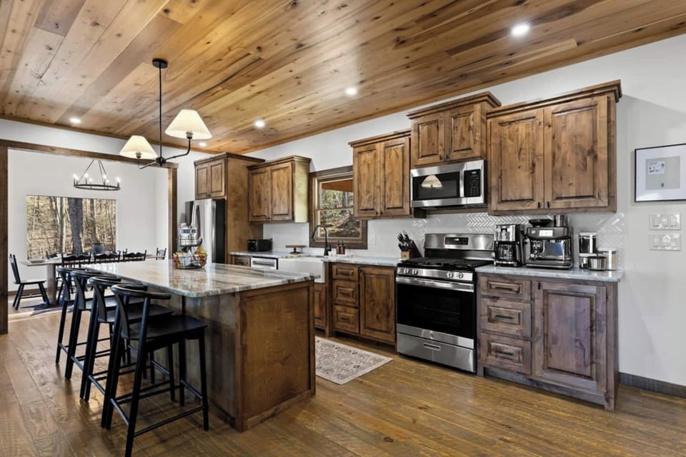 Thoughtfully designed kitchen fully stocked for entertaining, comfortably accommodating up to 12 guests with premium appliances, generous counter space, and elegant plates and silverware.
