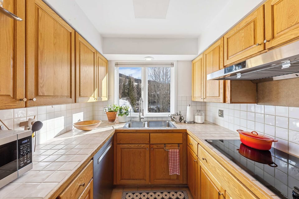 Kitchen. bright, compact, Double sink with a window view  and kitchen essentials