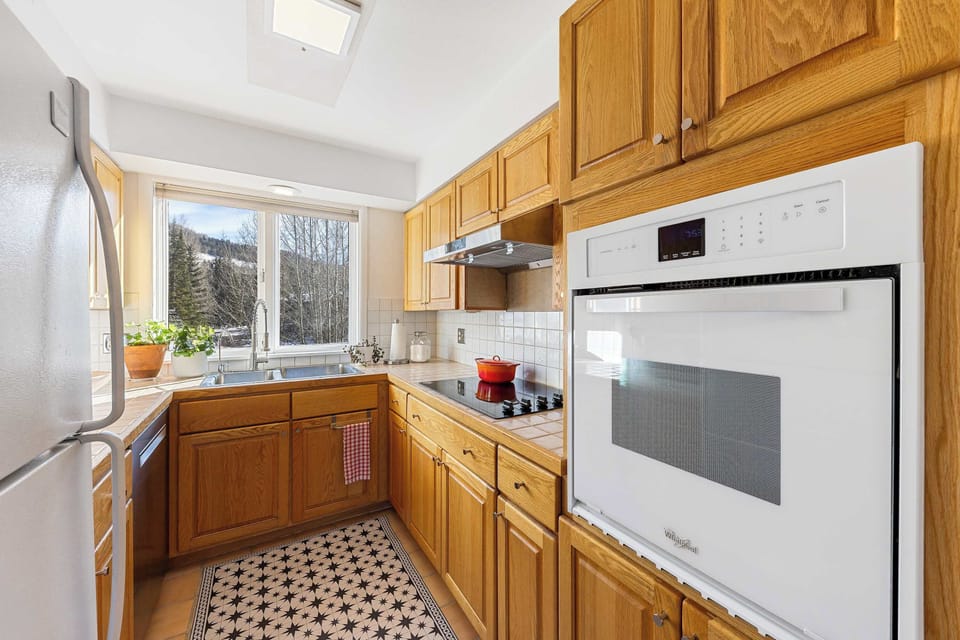Kitchen. bright, compact, Double sink with a window view  and kitchen essentials