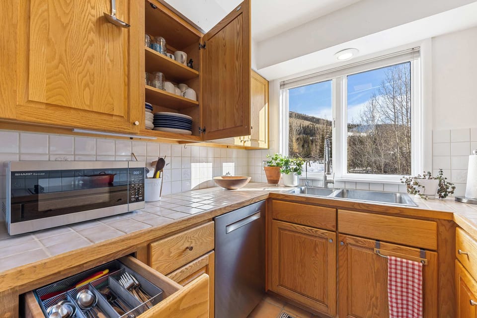 Kitchen. bright, compact, Double sink with a window view  and kitchen essentials