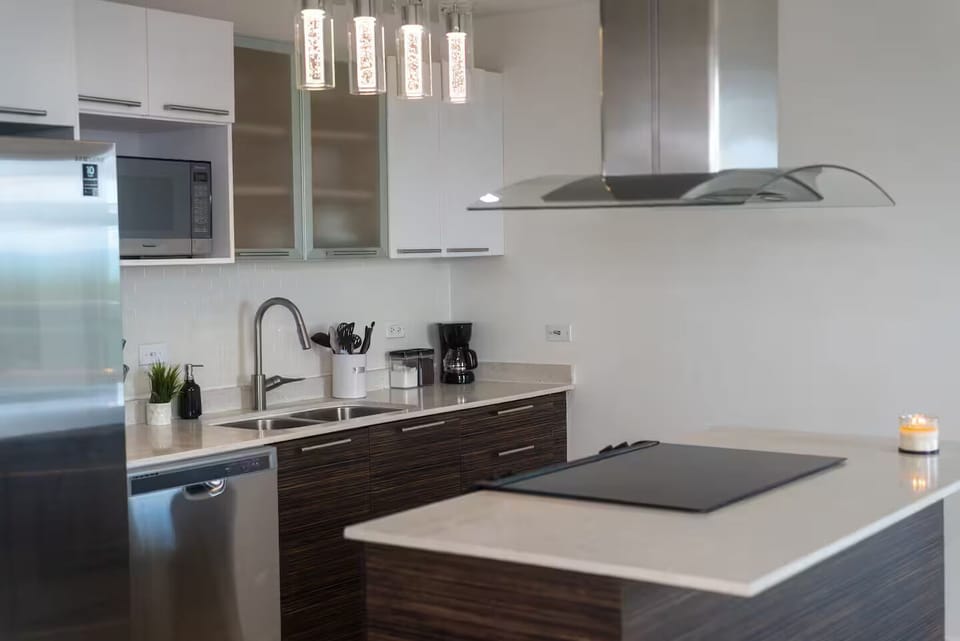 Full kitchen with cooktop, Oven, Dishwasher, Refrigerator and Microwave.