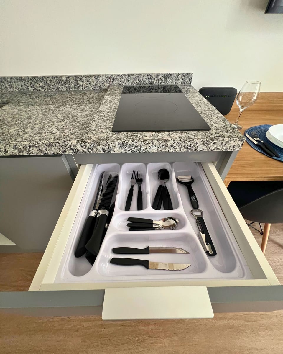 Full-size fridge, microwave, stovetop, cookware/dishes/utensils