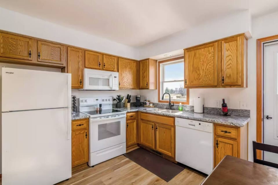 Functional kitchen w/ wood cabinetry, ample counter space & easy cooking layout