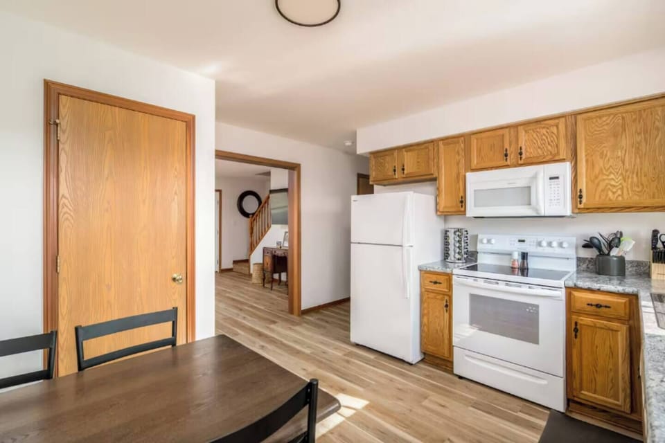 Kitchen w/ extended counters, wood cabinets & practical layout