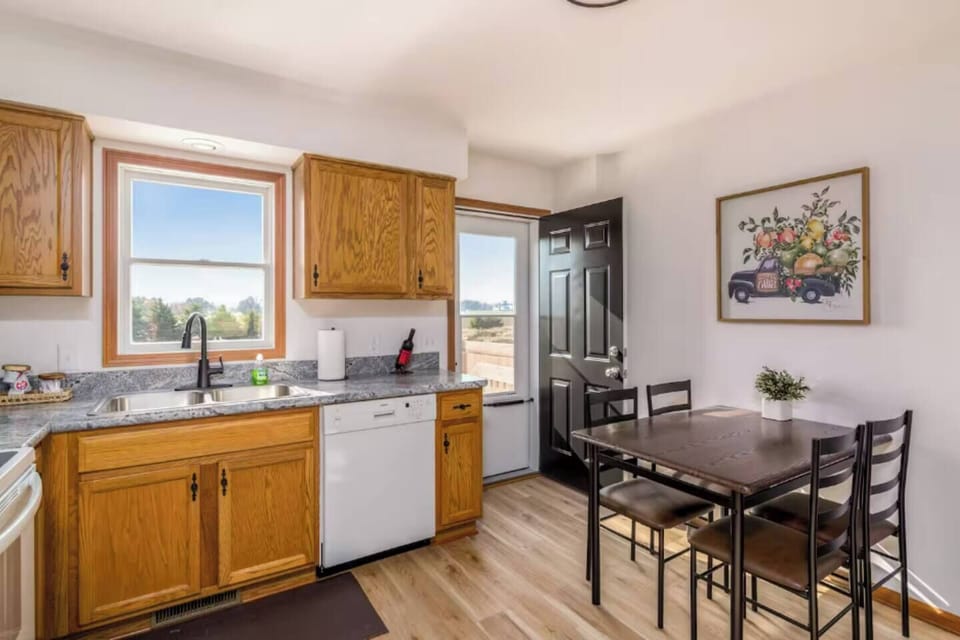 Dining area w/ table setup beside windows, perfect for relaxed meals together