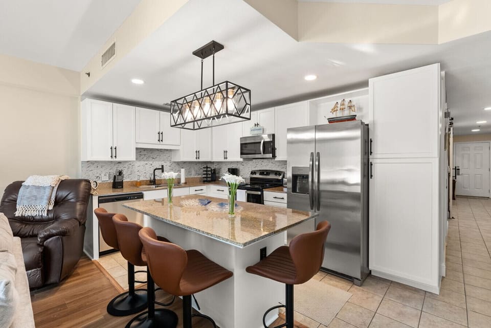 Stylish kitchen island offers seating for four and overlooks the open living area